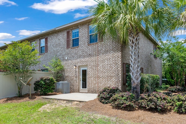 2131 Wilsons Plover Cir, Navarre, FL 32566 - back of house featuring brick siding, a patio area, and central air condition unit