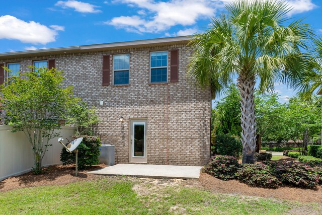 2131 Wilsons Plover Cir, Navarre, FL 32566 - rear view of property with cooling unit, a patio, and brick siding