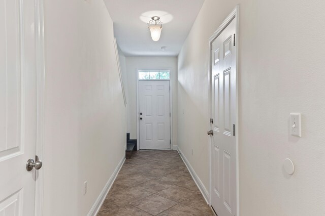 2131 Wilsons Plover Cir, Navarre, FL 32566 - entryway with baseboards and light stone finish floors