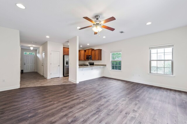 2131 Wilsons Plover Cir, Navarre, FL 32566 - unfurnished living room featuring a ceiling fan, dark wood-type flooring, recessed lighting, and baseboards