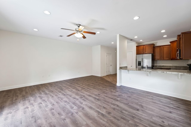 2131 Wilsons Plover Cir, Navarre, FL 32566 - kitchen featuring appliances with stainless steel finishes, a kitchen breakfast bar, a ceiling fan, recessed lighting, and light stone countertops