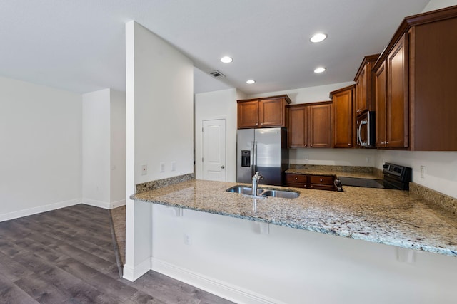 2131 Wilsons Plover Cir, Navarre, FL 32566 - kitchen with stainless steel appliances, a sink, light stone counters, recessed lighting, and dark wood-style flooring