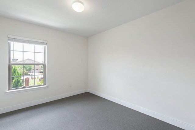 2131 Wilsons Plover Cir, Navarre, FL 32566 - unfurnished room featuring baseboards and dark carpet