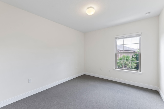 2131 Wilsons Plover Cir, Navarre, FL 32566 - unfurnished room featuring baseboards, dark carpet, and a smoke detector