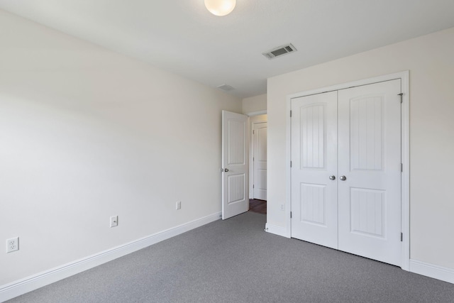 2131 Wilsons Plover Cir, Navarre, FL 32566 - unfurnished bedroom featuring a closet, dark colored carpet, and baseboards