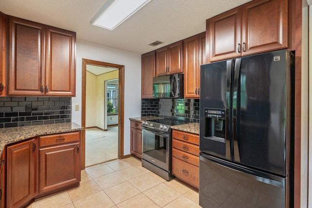 805 Turnberry Way, Niceville, FL 32578 - kitchen featuring black appliances, dark stone counters, backsplash, and light tile patterned floors