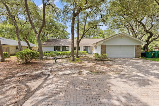 1127 Muirfield Way, Niceville, FL 32578 - view of front of house with decorative driveway, a garage, and brick siding