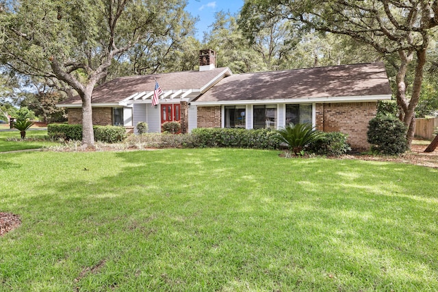 1127 Muirfield Way, Niceville, FL 32578 - single story home with brick siding, a front lawn, a chimney, and roof with shingles