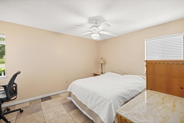 1127 Muirfield Way, Niceville, FL 32578 - bedroom with ceiling fan, an office area, and a textured ceiling