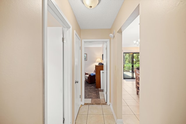 1127 Muirfield Way, Niceville, FL 32578 - hall with light tile patterned floors and a textured ceiling
