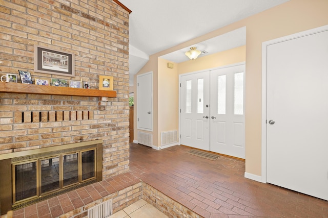 1127 Muirfield Way, Niceville, FL 32578 - entrance foyer featuring brick floors and a fireplace
