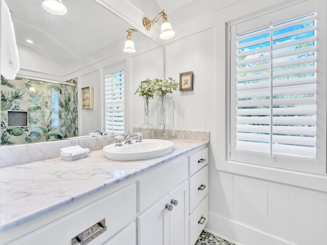 125 Silver Laurel Way, Santa Rosa Beach, FL 32459 - full bathroom with vanity, healthy amount of natural light, a shower, and a decorative wall