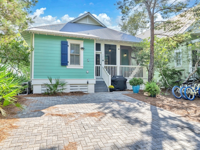 125 Silver Laurel Way, Santa Rosa Beach, FL 32459 - view of front of home with a metal roof and a sunroom