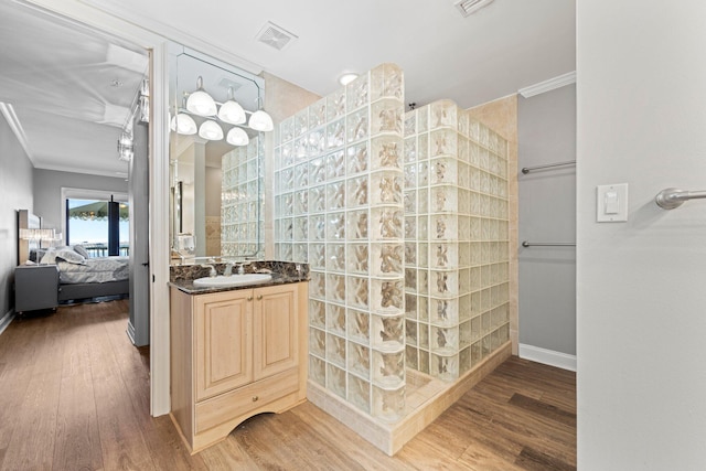 5 Calhoun Ave Unit 505, Destin, FL 32541 - full bathroom featuring ornamental molding, connected bathroom, walk in shower, wood finished floors, and vanity