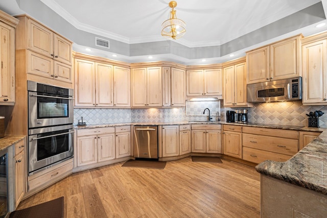 5 Calhoun Ave Unit 505, Destin, FL 32541 - kitchen with stainless steel appliances, light brown cabinets, crown molding, light wood finished floors, and recessed lighting