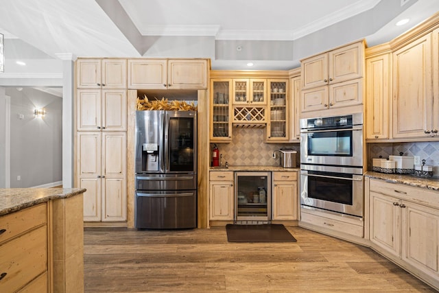5 Calhoun Ave Unit 505, Destin, FL 32541 - kitchen with appliances with stainless steel finishes, wine cooler, crown molding, tasteful backsplash, and light brown cabinetry