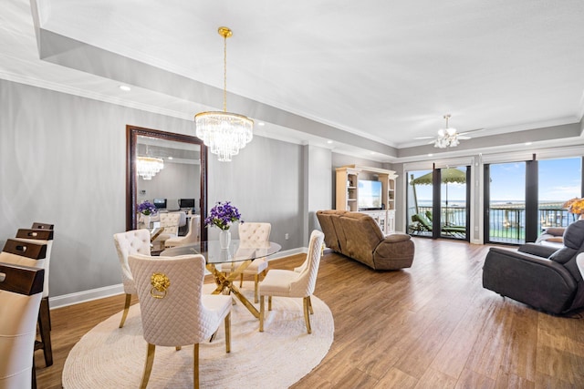 5 Calhoun Ave Unit 505, Destin, FL 32541 - dining space featuring a raised ceiling, a chandelier, wood finished floors, crown molding, and baseboards