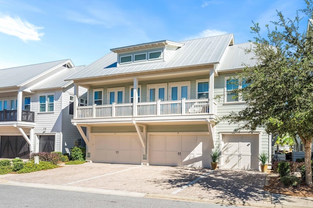 62 Dune Comet Ln Unit B, Inlet Beach, FL 32461 - view of property featuring driveway, a garage, and metal roof