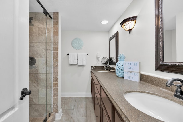 291 Scenic Gulf Dr Unit 201, Miramar Beach, FL 32550 - bathroom with a shower stall, double vanity, marble finish floors, baseboards, and recessed lighting