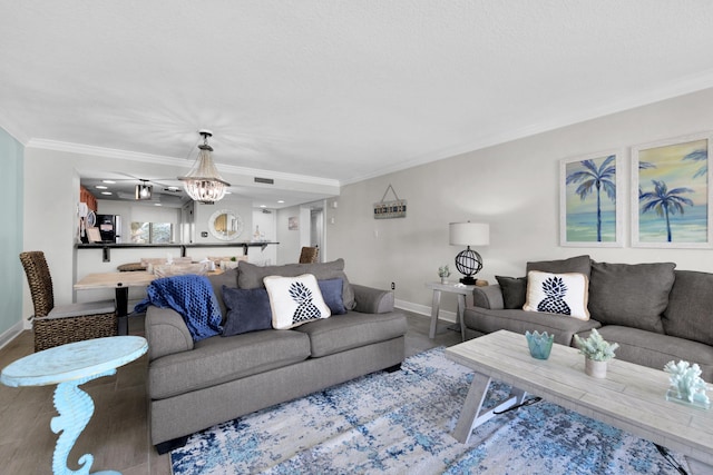 291 Scenic Gulf Dr Unit 201, Miramar Beach, FL 32550 - living room featuring crown molding, baseboards, wood finished floors, and a chandelier
