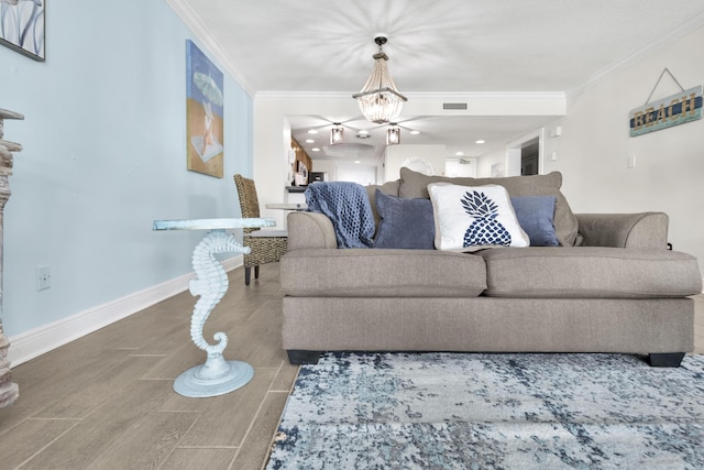 291 Scenic Gulf Dr Unit 201, Miramar Beach, FL 32550 - living area featuring crown molding, wood finished floors, a chandelier, and baseboards