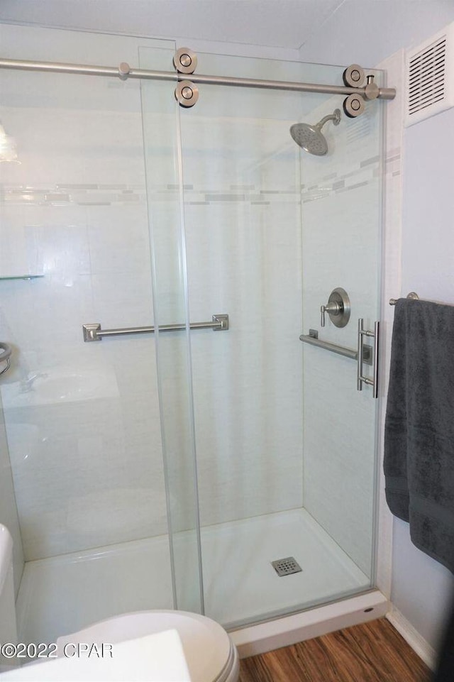 504 Lighthouse Rd Unit 504, Panama City Beach, FL 32407 - full bath with toilet, a shower stall, and wood finished floors
