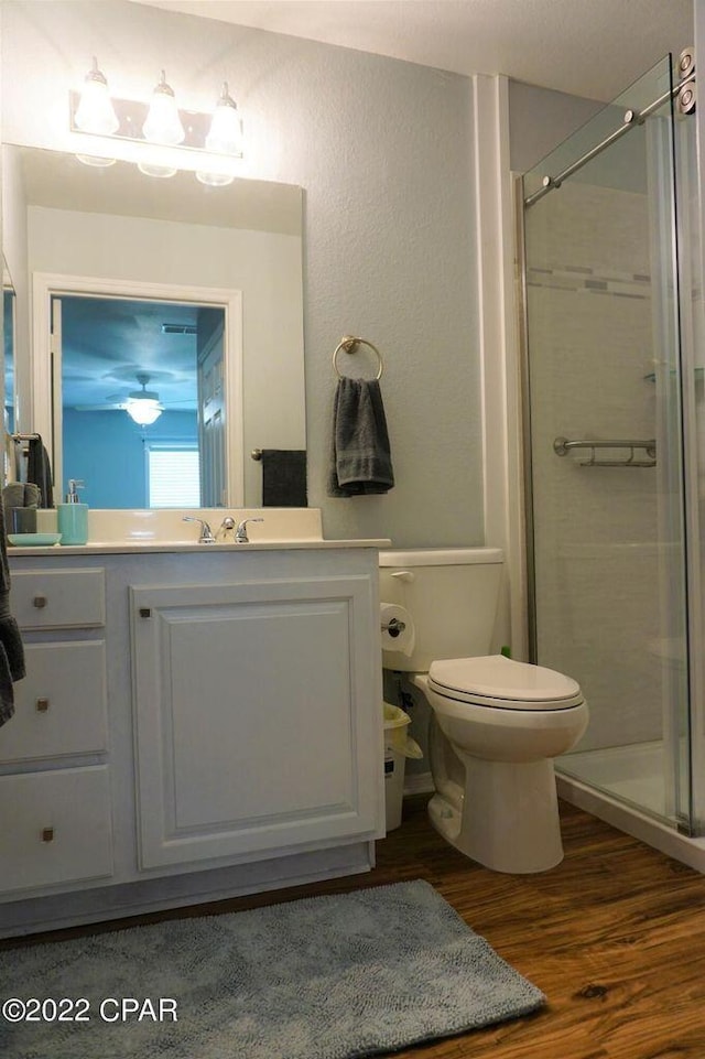 504 Lighthouse Rd Unit 504, Panama City Beach, FL 32407 - full bath featuring a stall shower, vanity, wood finished floors, and toilet