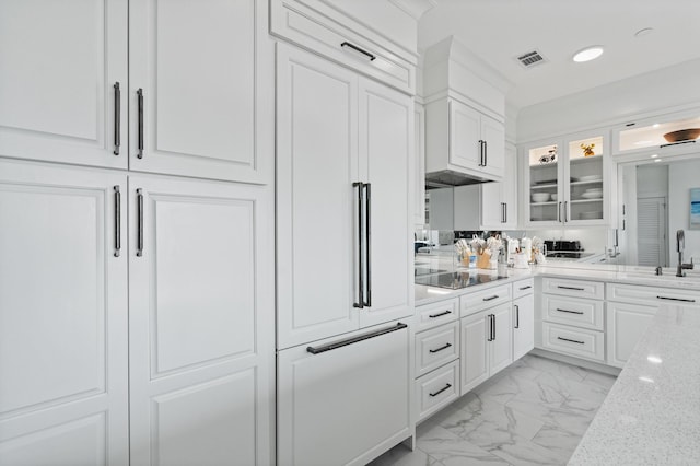 206 Henderson Resort Way Unit 5401, Destin, FL 32541 - kitchen with light marble finish flooring, glass insert cabinets, white cabinets, a sink, and paneled built in refrigerator