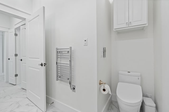 206 Henderson Resort Way Unit 5401, Destin, FL 32541 - bathroom with radiator, marble look tile flooring, toilet, and baseboards