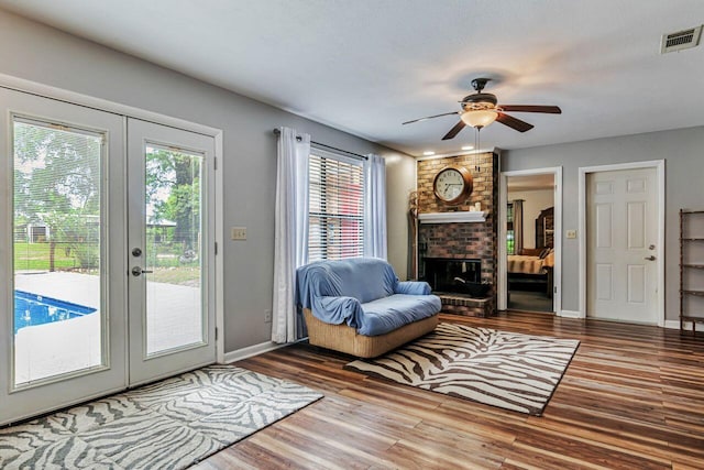 3544 State Highway 85, Laurel Hill, FL 32567 - living area featuring wood finished floors, french doors, a ceiling fan, and a brick fireplace