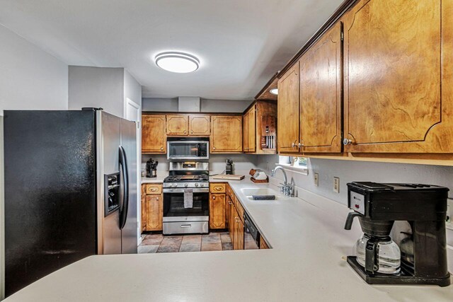 3544 State Highway 85, Laurel Hill, FL 32567 - kitchen featuring stainless steel appliances, light countertops, and brown cabinetry
