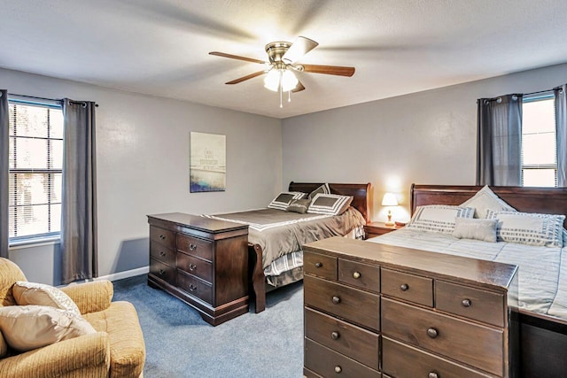 3544 State Highway 85, Laurel Hill, FL 32567 - bedroom with dark carpet, multiple windows, and a ceiling fan