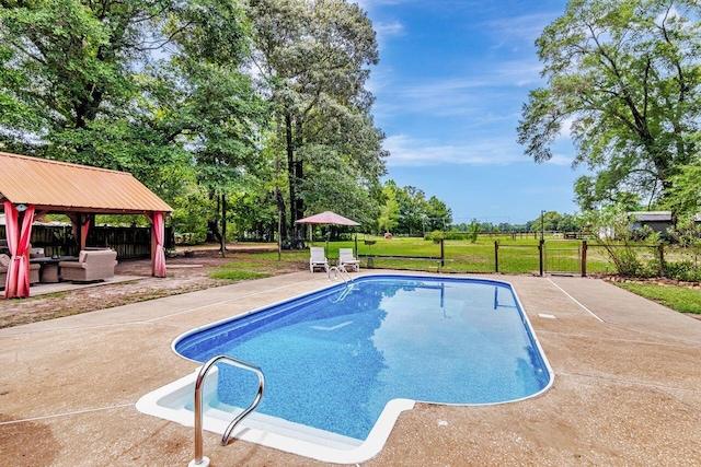 3544 State Highway 85, Laurel Hill, FL 32567 - swimming pool with a gazebo, a patio area, an outdoor hangout area, and view of wooded area