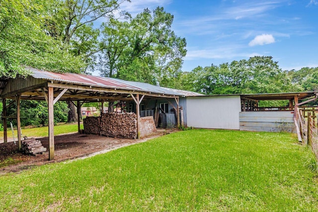 3544 State Highway 85, Laurel Hill, FL 32567 - view of yard featuring a carport, an exterior structure, and an outbuilding