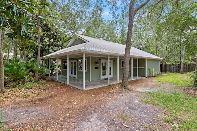 180 E Mitchell Ave, Santa Rosa Beach, FL 32459 - view of front of home featuring french doors, metal roof, and dirt driveway