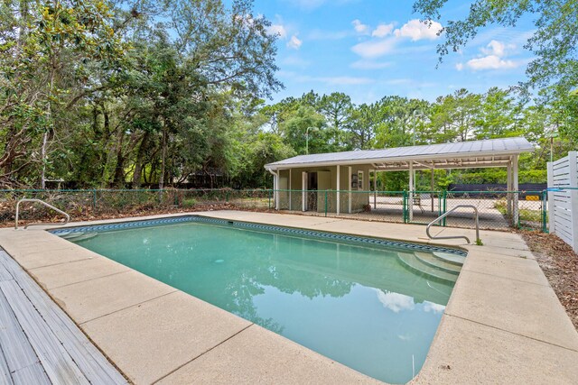180 E Mitchell Ave, Santa Rosa Beach, FL 32459 - view of swimming pool with view of scattered trees and a patio area