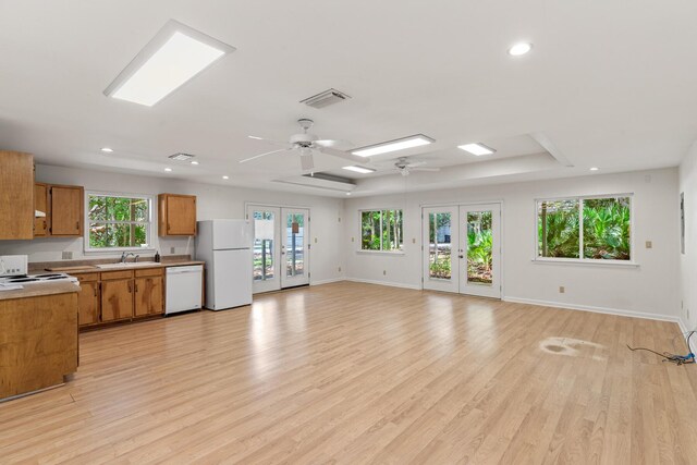180 E Mitchell Ave, Santa Rosa Beach, FL 32459 - kitchen with white appliances, french doors, brown cabinetry, ceiling fan, and light countertops