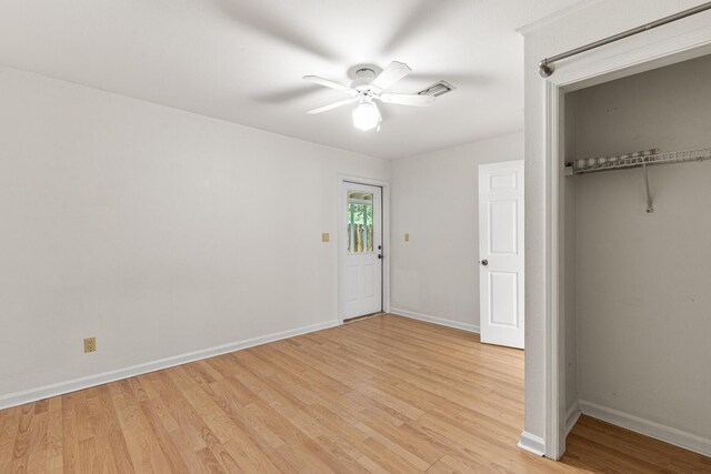180 E Mitchell Ave, Santa Rosa Beach, FL 32459 - unfurnished bedroom with light wood-style flooring, baseboards, a closet, and a ceiling fan