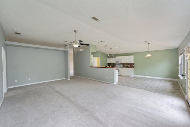 488 Jillian Dr, Crestview, FL 32536 - unfurnished living room featuring light carpet, a ceiling fan, and vaulted ceiling