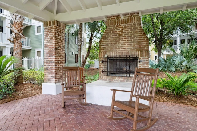 9100 Baytowne Wharf Blvd Unit 261, Miramar Beach, FL 32550 - view of patio / terrace featuring an outdoor brick fireplace