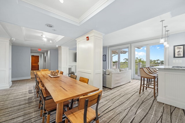 9100 Baytowne Wharf Blvd Unit 261, Miramar Beach, FL 32550 - dining room featuring a raised ceiling, crown molding, light carpet, and decorative columns
