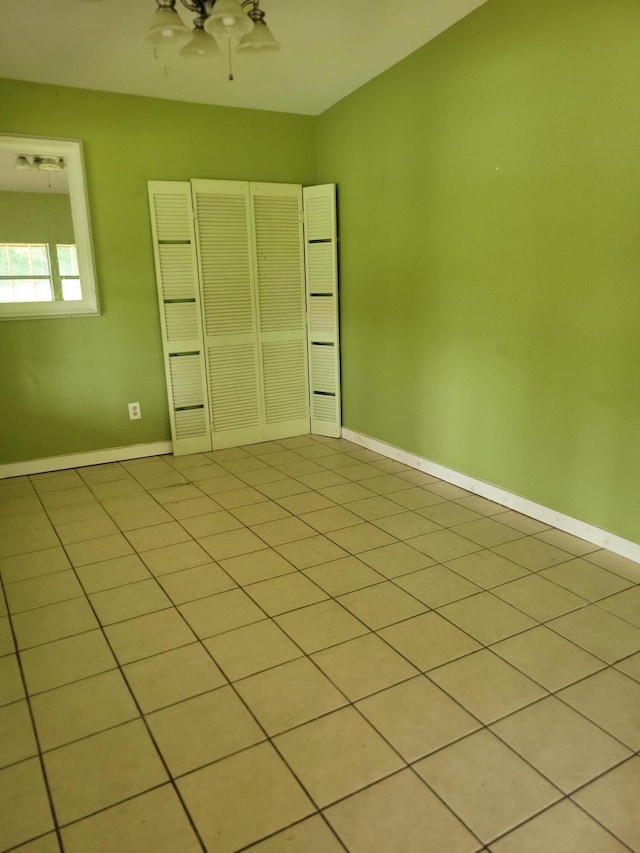 1989 Juniper Lake Rd, Defuniak Springs, FL 32433 - unfurnished bedroom with baseboards, a ceiling fan, and light tile patterned floors