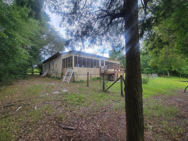1989 Juniper Lake Rd, Defuniak Springs, FL 32433 - rear view of house featuring a sunroom and a deck