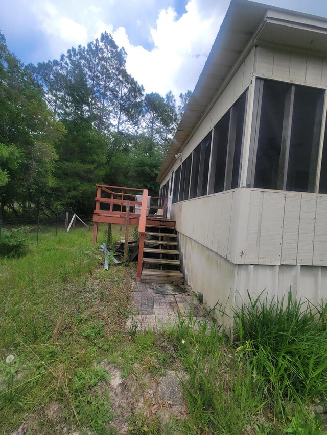 1989 Juniper Lake Rd, Defuniak Springs, FL 32433 - view of side of home featuring stairway, a deck, and a sunroom