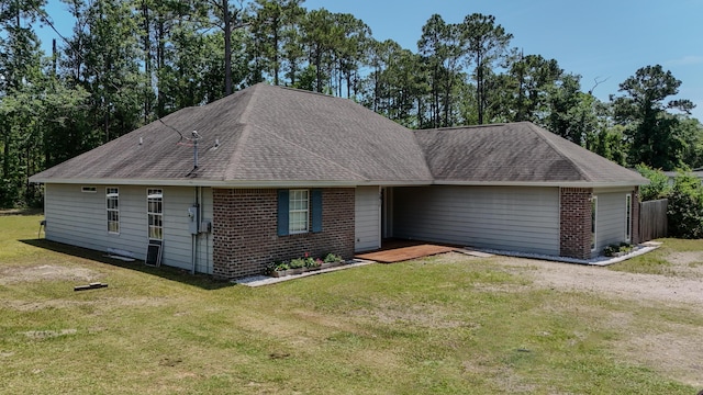 241 Mullet Dr, Freeport, FL 32439 - view of front of home featuring brick siding, roof with shingles, and a front lawn