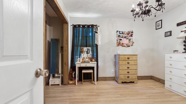 241 Mullet Dr, Freeport, FL 32439 - bedroom with light wood-type flooring and a chandelier