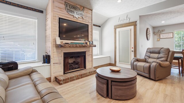 241 Mullet Dr, Freeport, FL 32439 - living room with wood finished floors, a brick fireplace, baseboards, vaulted ceiling, and recessed lighting