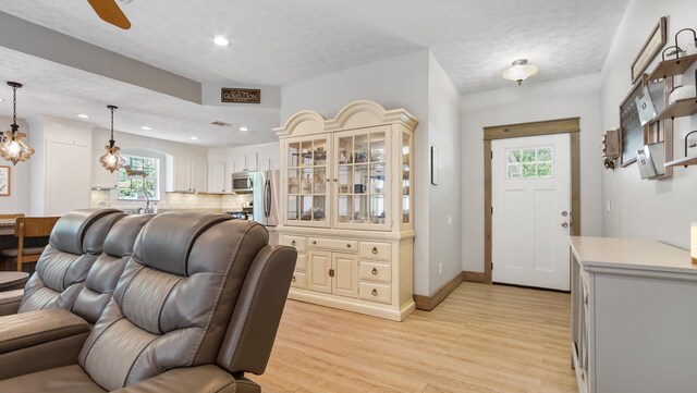 241 Mullet Dr, Freeport, FL 32439 - living room featuring light wood finished floors, recessed lighting, ceiling fan, baseboards, and arched walkways