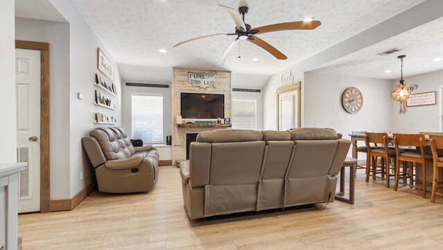 241 Mullet Dr, Freeport, FL 32439 - living area with a ceiling fan, a textured ceiling, light wood-style flooring, a fireplace, and recessed lighting