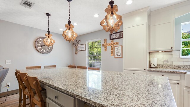241 Mullet Dr, Freeport, FL 32439 - kitchen with plenty of natural light, a chandelier, light stone counters, and recessed lighting